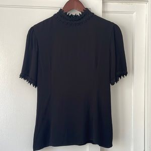 Black high neck top with neck and sleeve details